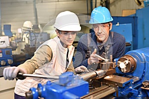 Young woman apprentice learning metallurgic work