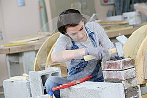 Young woman apprentice in masonry
