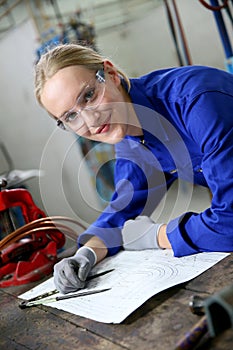 Young woman apprentice in plumbery