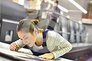 Young woman apprentice in printing indutry photo