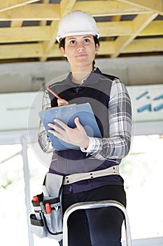 young woman architect on ladder