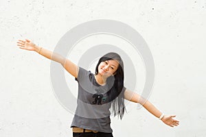 Young woman with arms spread wide open