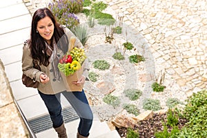 Young woman arriving home groceries shopping smiling