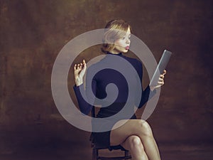 Young woman in art action  on brown background. Retro style, comparison of eras concept.