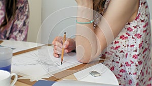 Young woman artist painting at home studio creative tools close-up