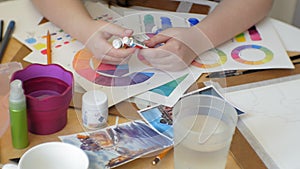 Young woman artist painting at home studio creative tools close-up