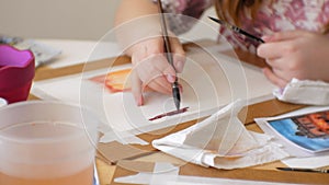 Young woman artist painting at home studio creative tools close-up