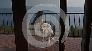 Young woman artist working on portrait on verandah above the sea