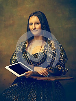 Young woman as Mona Lisa on dark background. Retro style, comparison of eras concept.