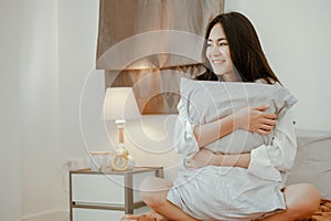 Young woman asia living at home relaxing and reading a book in the bedroom on holiday