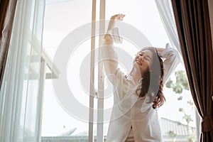 Young woman asia living at home relaxing and drinking cup of hot coffee in the bedroom on holiday.