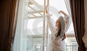 Young woman asia living at home relaxing and drinking cup of hot coffee in the bedroom on holiday.