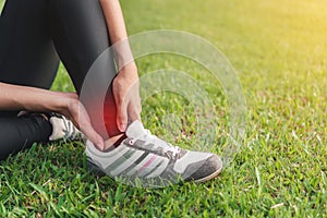 Young woman asian have accident ankle twist sprain in sport exercise jogging, selective focus, Exercise and healthy concept