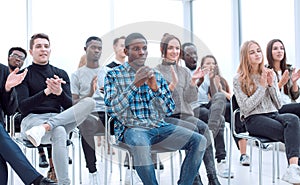 young woman asks a question at a business seminar.