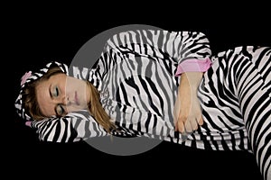 Young woman asleep laying down wearing striped pajamas