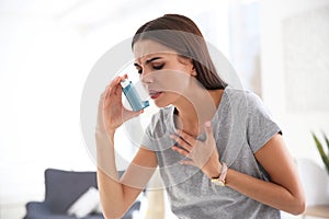 Young woman with asthma inhaler photo
