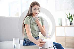 Young woman with asthma machine