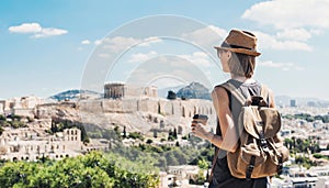 Young woman in Athens with Acropolis at the background. Traveler girl enjoying vacation in Greece.