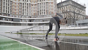 Young woman athlete sprinting in front of camera on a run path running athletic track. 120fps