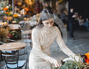 A young woman attends a masterclass to learn the art of crafting Christmas decorations.