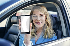 Young woman in auto shows smartphone with blank screen.