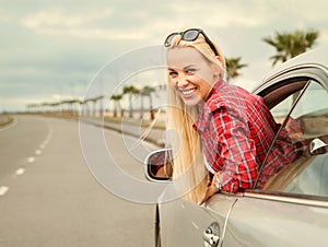 Young woman auto traveler on the highway