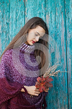 Portrait of a pretty young teenage girl 13-16 years old. Young woman with autumn flowers closeup