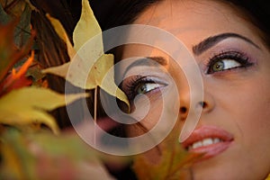 Young woman with autumn leaves