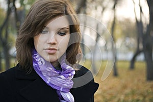 Sad young fashion woman walking in autumn park photo