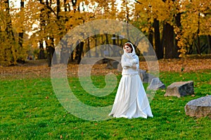 Young woman in a autumn park. Lady with a leafs