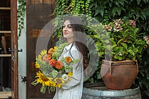 Young Woman with Autumnal Flower Bouquet