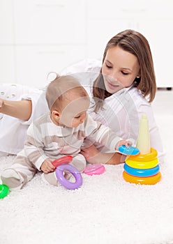 Young woman with baby girl playing