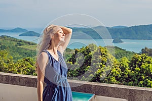 Young woman in the background of Tropical beach landscape panorama. Beautiful turquoise ocean waives with boats and sandy coastlin