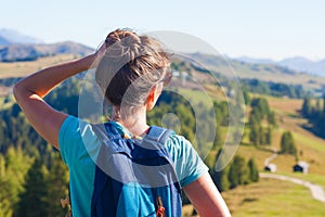 Young woman with backpack hiking at Alta Badia, Dolomites, Italy