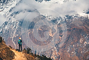 Young woman with backpack on the mountain peak