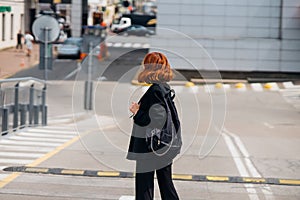 Young woman with a backpack on the road