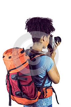 Young woman with backpack taking picture