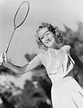 Young woman with a badminton racket photo
