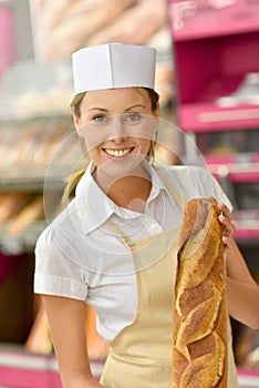 Young woman baker selling bread
