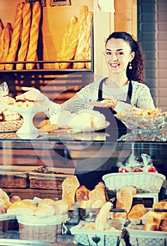 Young woman at bakery display photo