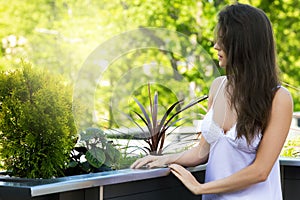 Young woman on the balcony at morning