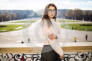 young woman on balkon of house on park background