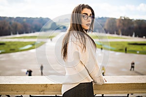 Young woman on balkon of house on park background