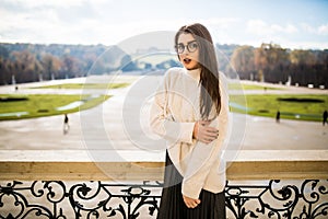 Young woman on balkon of house on park background