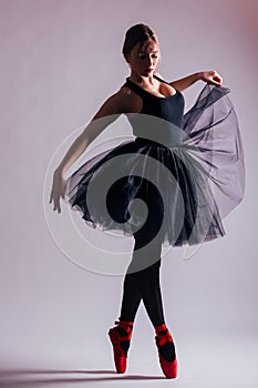 Young woman ballerina ballet dancer dancing with tutu in silhouette