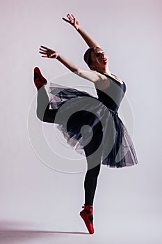 Young woman ballerina ballet dancer dancing with tutu in silhouette