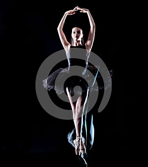 Young woman ballerina  dancer dancing isolated black background light painting