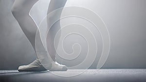 Young woman ballerina dancing on her pointes on the stage