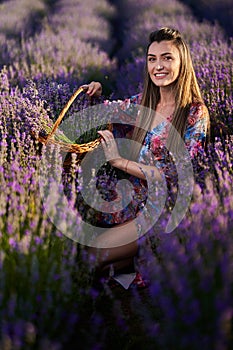 Young woman with a basket in a lavender field