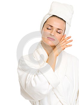 Young woman in bathrobe enjoying freshness
